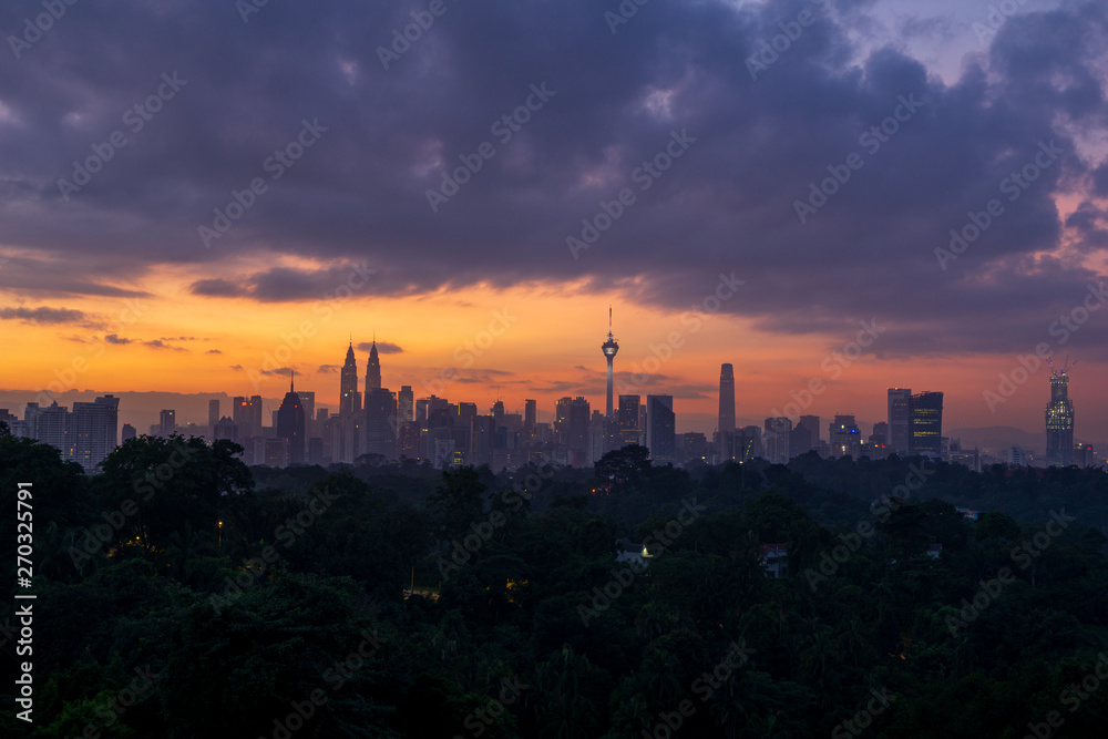 Cloudy sunrise over downtown Kuala Lumpur (KL). KL is the capital of Malaysia. 
