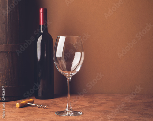 Bottle of wine empty wine glass dark background. Copy space. Still life style dark. Selective focus. Horizontal frame