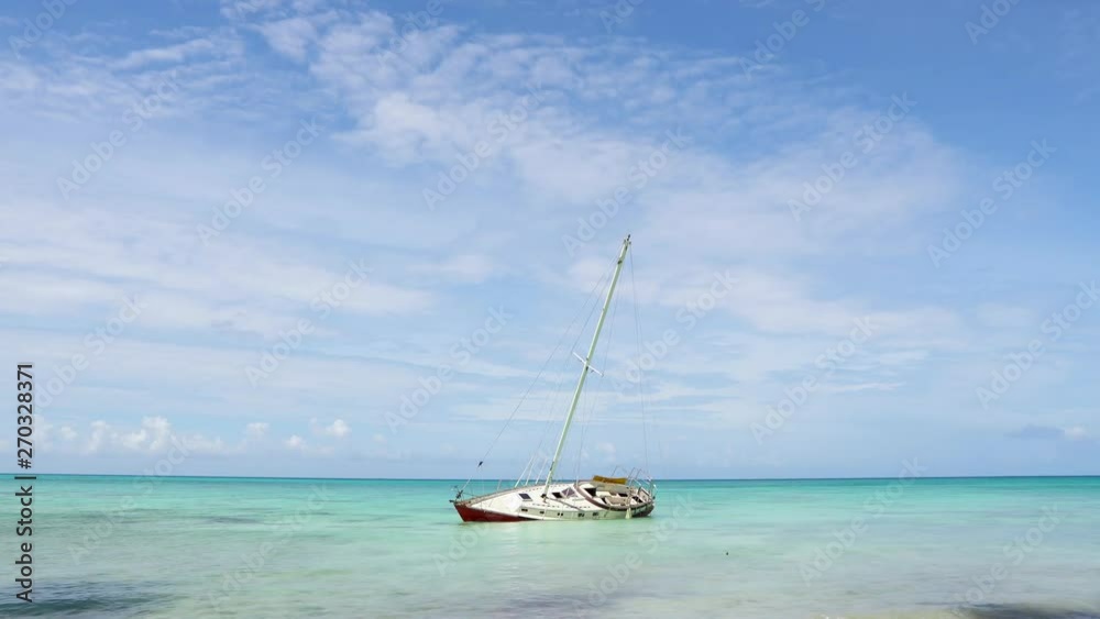 Shipwreck, the yacht ran aground in the Caribbean. Shipwreck in the Atlantic Ocean. Abandoned yacht in the open sea near the beach. The yacht lies aground on its side. Dominican republic isle Saona Shipwreck, the yacht ran aground in the Caribbean. Shipwreck in the Atlantic Ocean. Abandoned yacht in the open sea near the beach. The yacht lies aground on its side. Dominican republic isle Saona