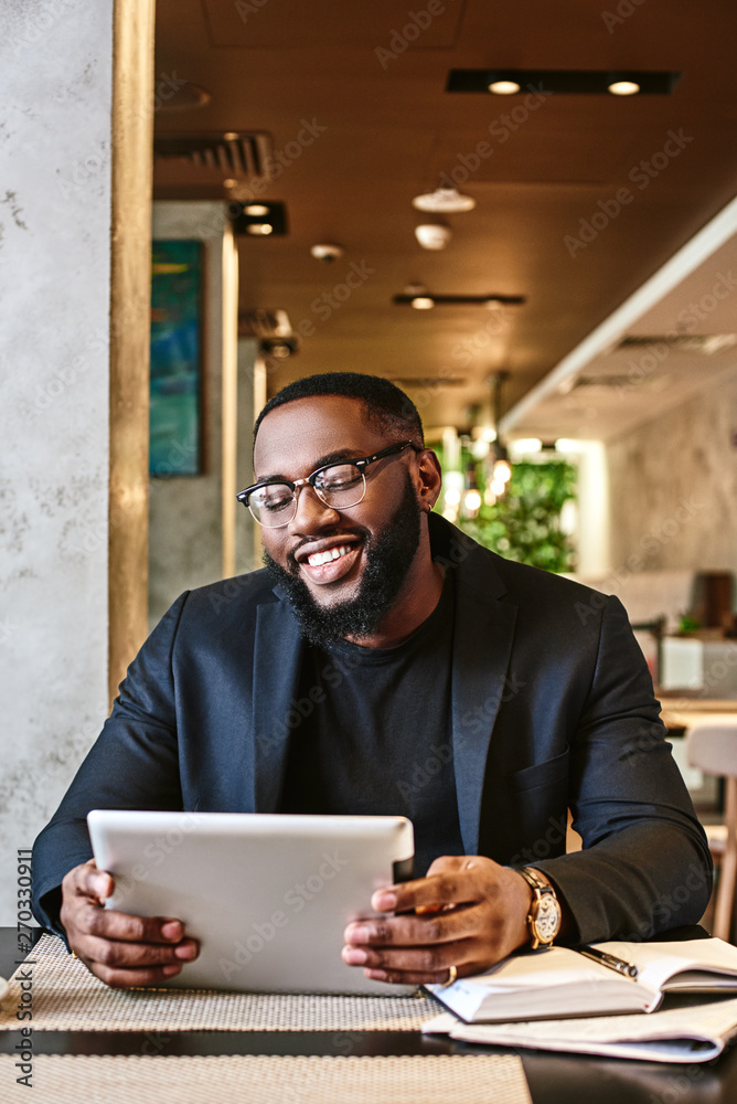 If the plan doesn t work, change the plan, but never the goal. Shot of a young afro american businessman using tablet while resting in the cafe If the plan doesn t work, change the plan, but never the goal. Shot of a young afro american businessman using tablet while resting in the cafe