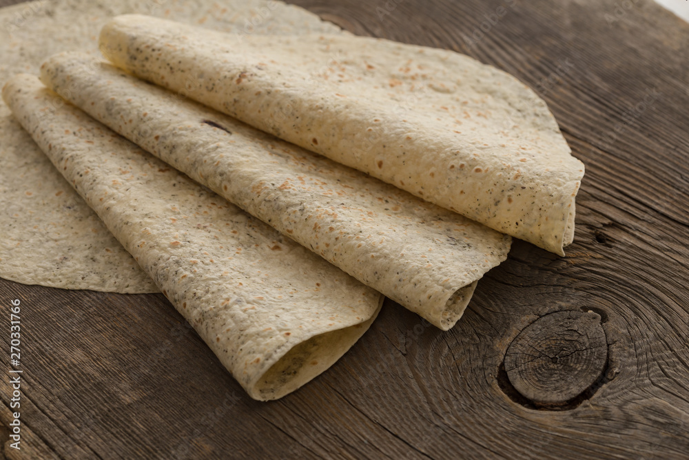 Lavash, tortilla, lavaş, flat and thin bread on table Lavash, tortilla, lavaş, flat and thin bread on table