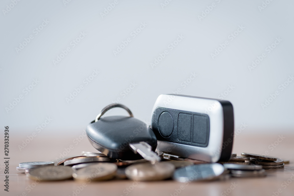 car keys and metal coins on wooden surface isolated on grey car keys and metal coins on wooden surface isolated on grey