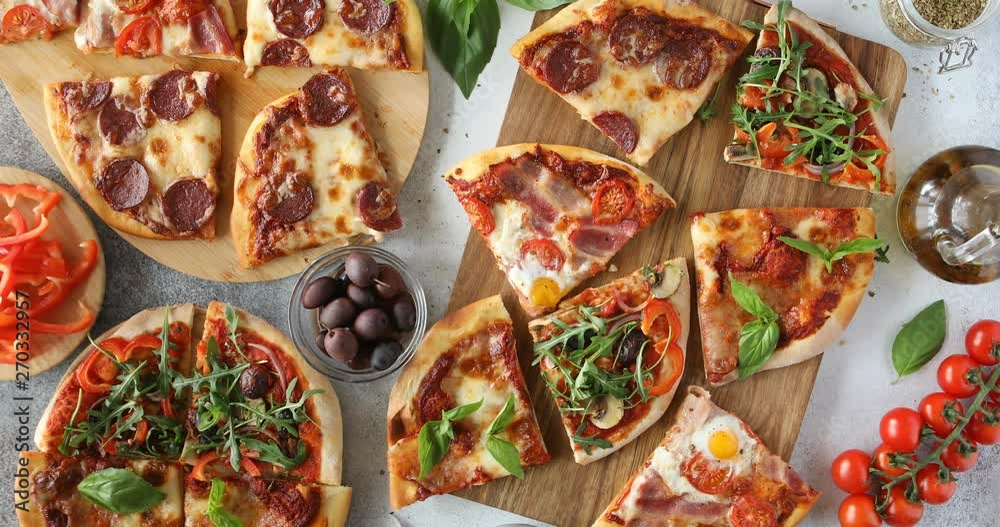 Top view of hands taking pizza cuts from boards on table. Group of people and food order eating.
