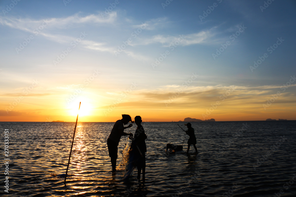 silhouette of fisherman family.