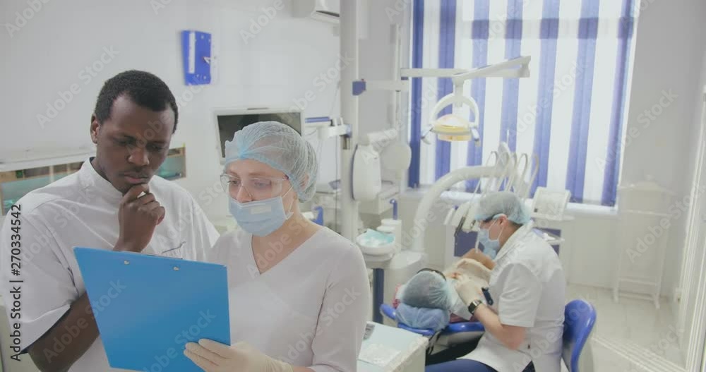 Doctors read in medical history serious diagnosis Doctors read in medical history serious diagnosis
