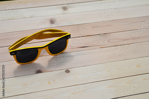 Sunglasses on the table with reflection sky