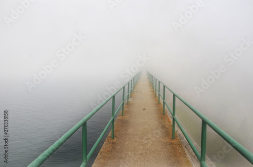 Pier with green handrails going into nowhere   