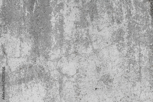 The texture of the old grey concrete wall with scratches, cracks, dust, crevices, roughness, stucco. Can be used as a poster or background for design © Sergey