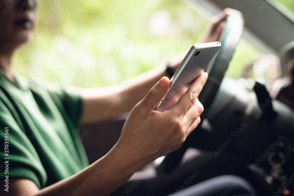 driver with a cell phone in hand while driving driver with a cell phone in hand while driving