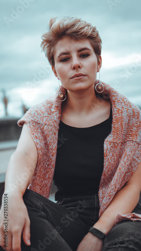 Принти на полотні Young woman with trendy short blonde hair outdoor portrait at city
