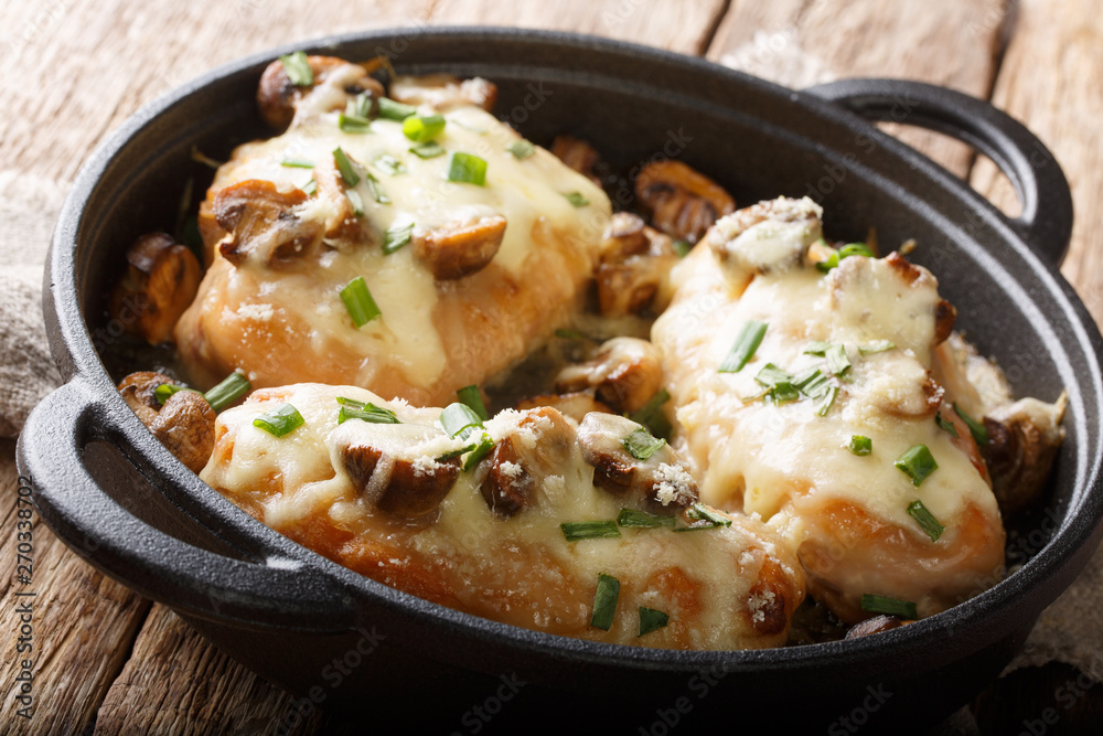 Lombardy Chicken breasts cooked with mushrooms, green onions, mozzarella cheese and parmesan closeup. horizontal Lombardy Chicken breasts cooked with mushrooms, green onions, mozzarella cheese and parmesan closeup. horizontal