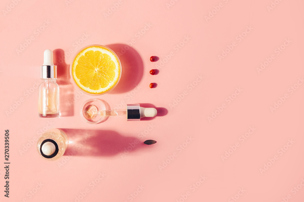 Naklejka premium Serum with vitamin C, concept design. Beauty therapy, body care. Minimalism Flat lay.