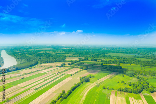 Beautiful countryside landscape in nature park Lonjsko polje  Croatia  from air  panoramic view  agriculture fields and flooded field in spring