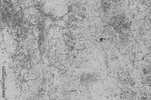 The texture of the old grey concrete wall with scratches, cracks, dust, crevi...