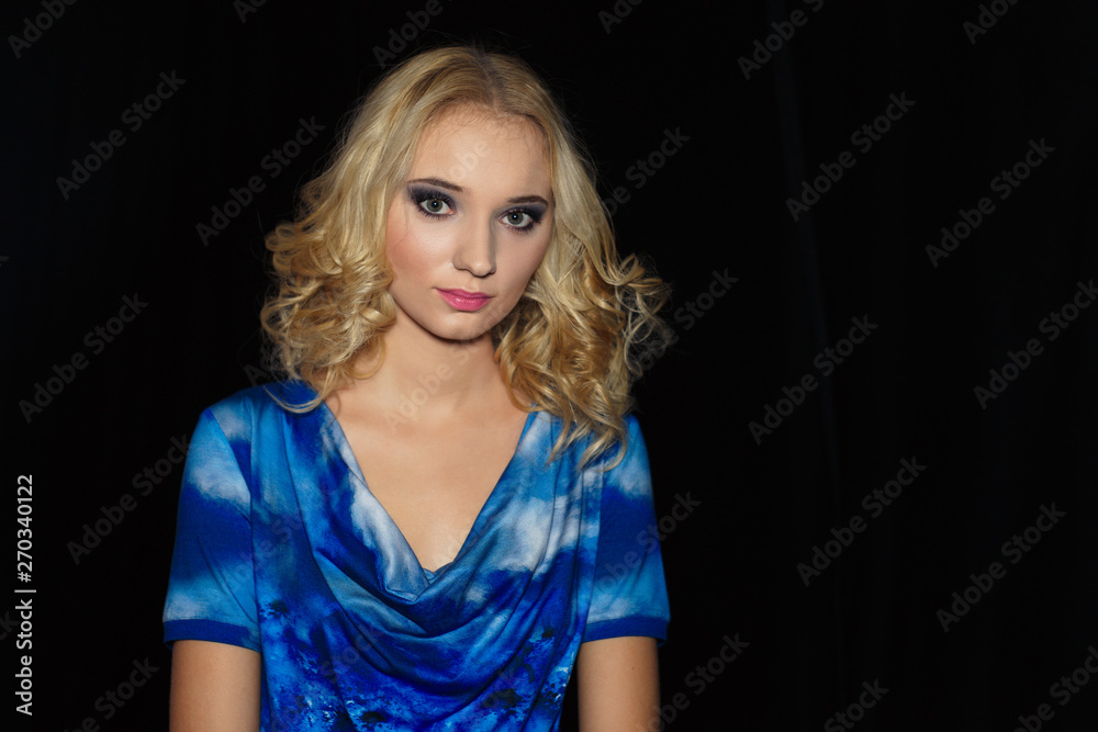 Portrait of beautiful girl with curly blonde hair on black background Portrait of beautiful girl with curly blonde hair on black background