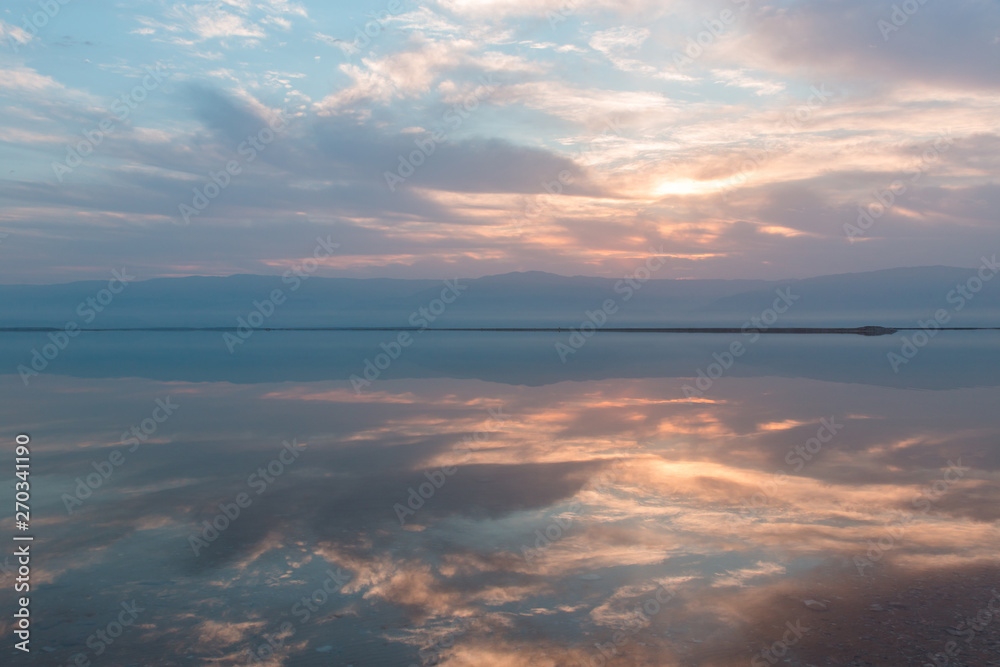Sunrise above the Dead sea, beautiful reflections on the water