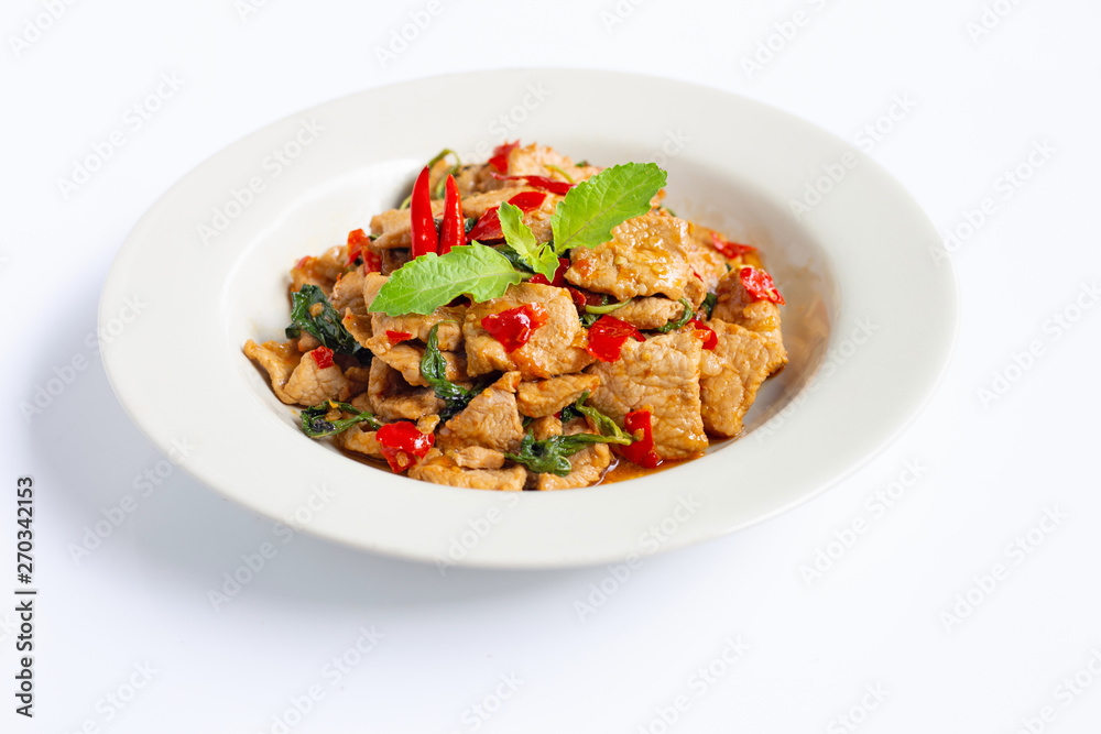 Stir-fried hot and spicy pork with holy basil on white Stir-fried hot and spicy pork with holy basil on white