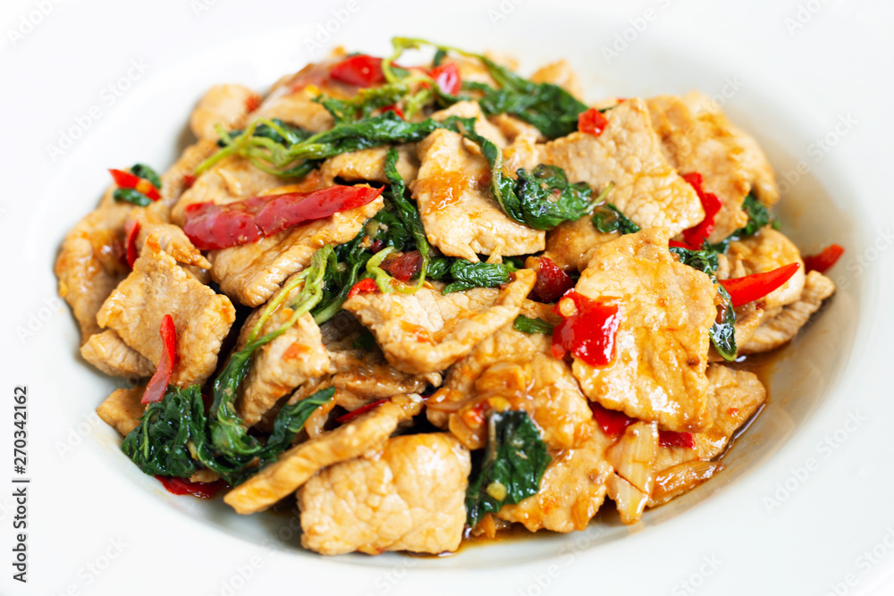 Stir-fried hot and spicy pork with basil on white Stir-fried hot and spicy pork with basil on white