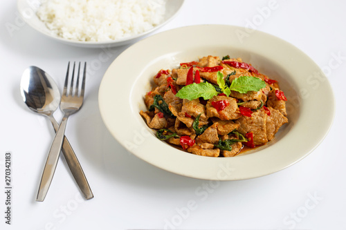 Stir-fried hot and spicy pork with holy basil on white