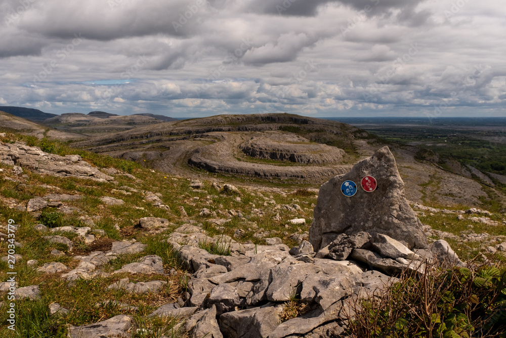 A view of Sliabh Rua, Red Mountain  from  Mullaghmore Mountain  in The Burren National Park with the signs for the various walking routes, nobody in the image