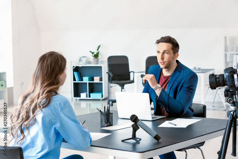 Human resources manager interviewing woman in office