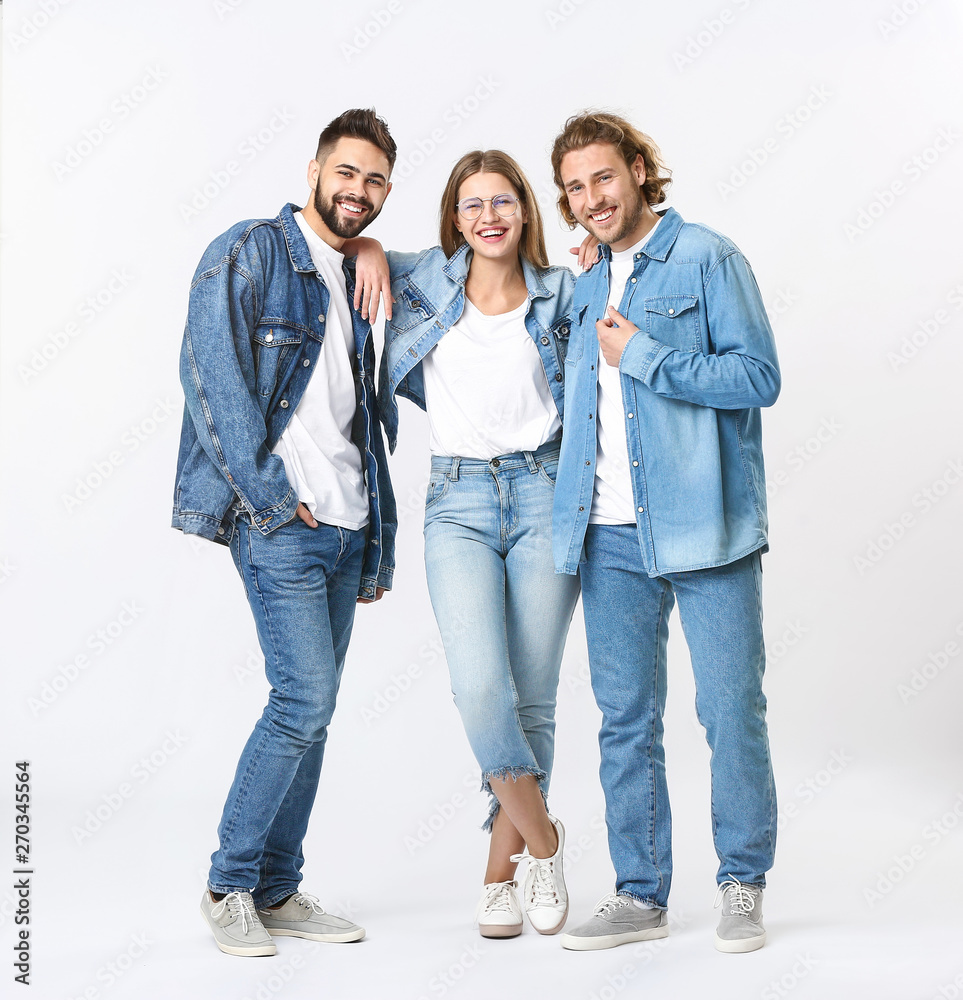 Fototapeta premium Stylish young people in jeans clothes on white background