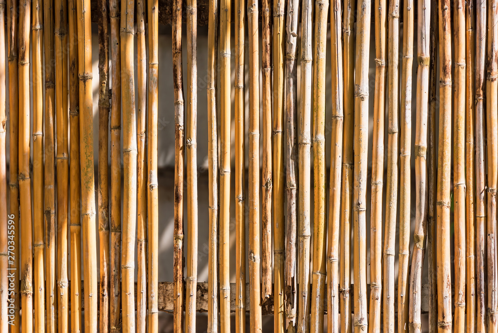 Close up decorative old bamboo wood of fence wall background. Close up decorative old bamboo wood of fence wall background.