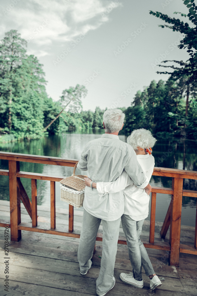 Full-sized picture of couple hugging and enjoying the beautiful scenery