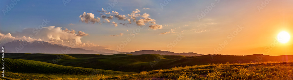 Panorama of a mountain valley in summer. Fabulous sunset in the mountains, amazing nature, summer in the mountains. Travel and camping, tourism