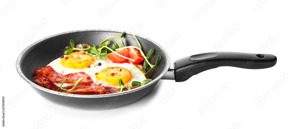 Frying pan with tasty eggs, bacon and tomato on white background Frying pan with tasty eggs, bacon and tomato on white background