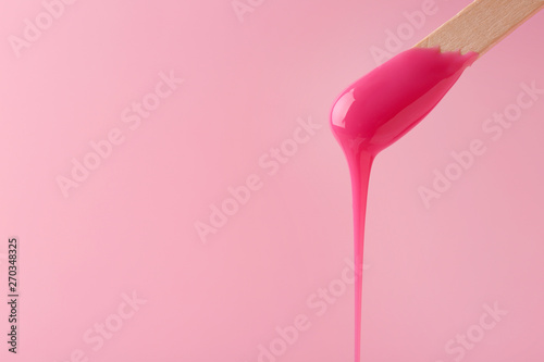 Obraz na plátně Stick with sugaring paste on color background