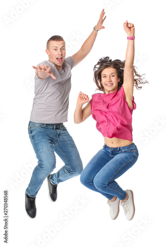 Jumping young couple on whi...