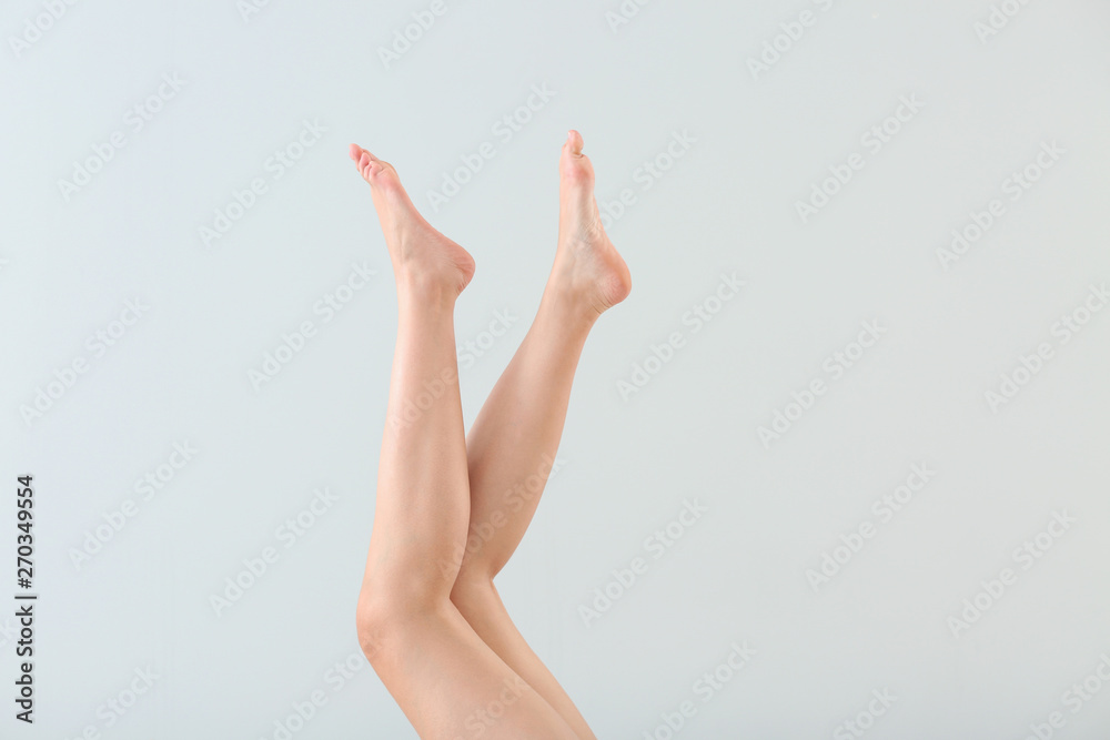 Legs of beautiful young woman after depilation on light background Legs of beautiful young woman after depilation on light background
