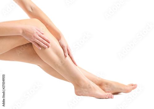 Legs of beautiful young woman after depilation on white background