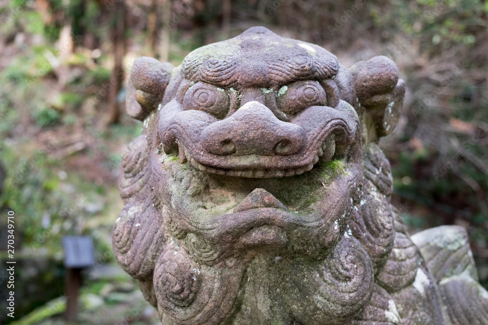 Close-up of ancient stone lion-dog sculpture next to Yoro waterfall. Gifu. Japan