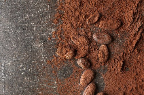 Cocoa powder and beans on table photo