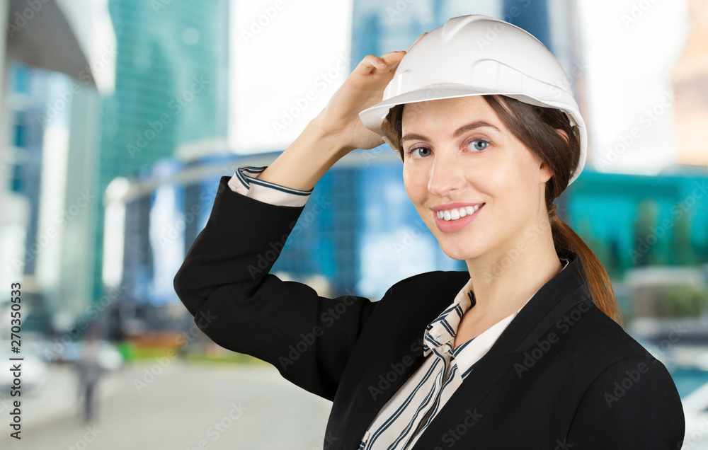 Portrait of a young female engineer wearing a safety helmet at work site Portrait of a young female engineer wearing a safety helmet at work site