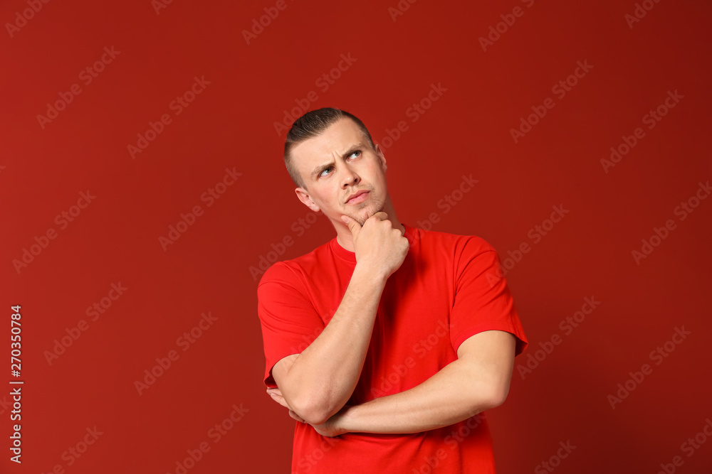 Thoughtful young man on color background Thoughtful young man on color background