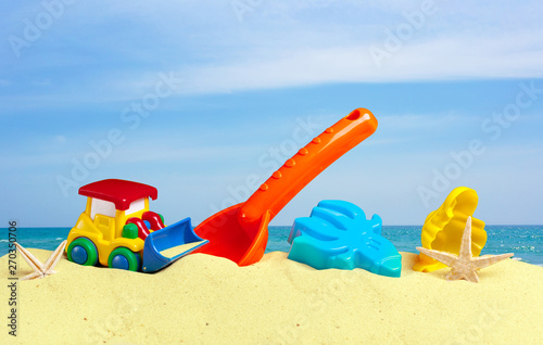 Wallpaper Mural colorful toys for child sandboxes against the beach sand background Torontodigital.ca
