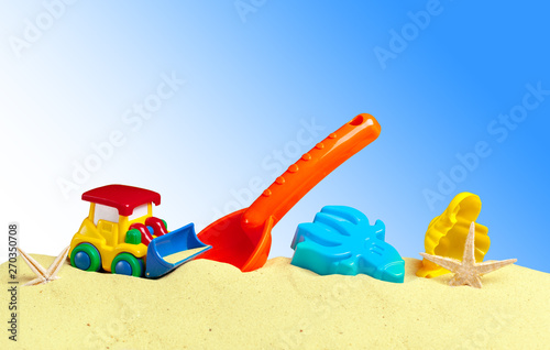 Wallpaper Mural colorful toys for child sandboxes against the beach sand background Torontodigital.ca
