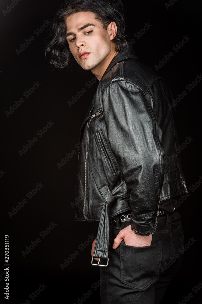 serious man standing with hand in pocket isolated on black serious man standing with hand in pocket isolated on black