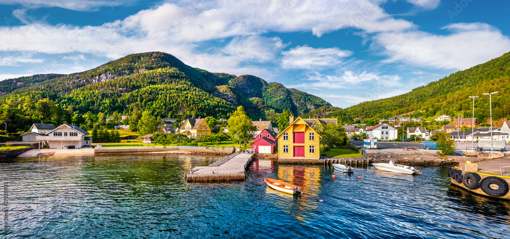 Picturesque summer view of typical Norwegian village on the shore of fjord. Traveling concept background.Artistic style post processed photo.