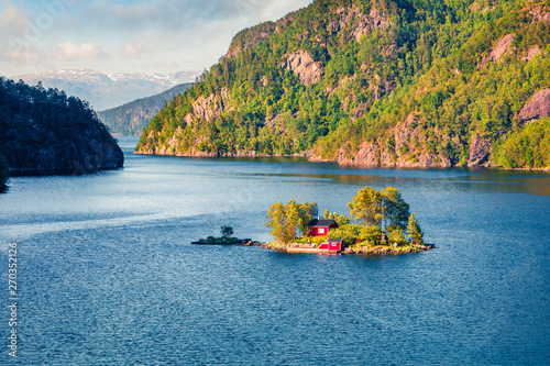 Magnificent summer view with small island with typical Norwegian building on Lovrafjorden flord, North sea. Colorful morning view in Norway. Beauty of nature concept background. photo