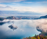 Aerial view of church of Assumption of Maria on the Bled lake. Foggy autumn landscape in Julian Alps, Slovenia, Europe. Beauty of countryside concept background.