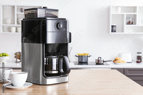 Fotografie Modern coffee machine on kitchen table