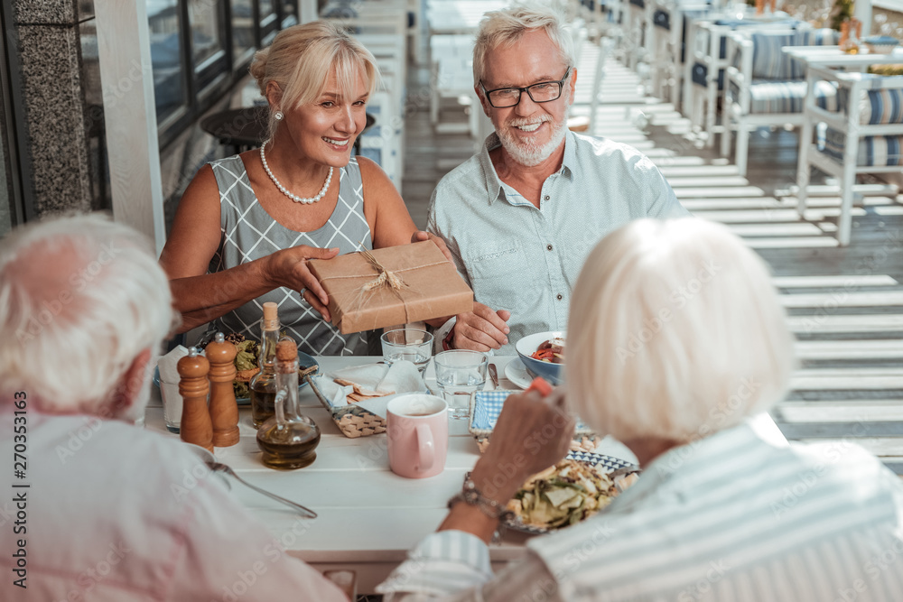 Positive delighted mature family visiting birthday party Positive delighted mature family visiting birthday party