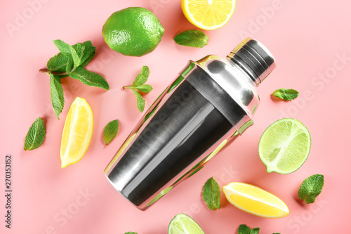 Fresh lime, lemon, shaker and mint leaves on color background photo