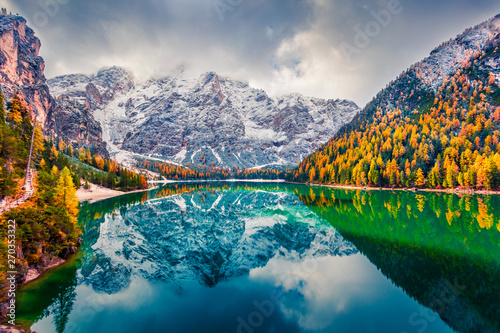 Fototapeta Naklejka Na Ścianę i Meble -  First snow on Braies Lake. Colorful autumn landscape in Italian Alps, Naturpark Fanes-Sennes-Prags, Dolomite, Italy, Europe. Beauty of nature concept background.