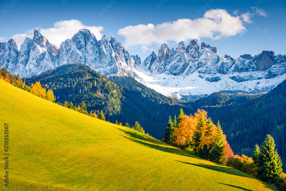 Magnificent view of Santa Maddalena village hills in front of the Geisler or Odle Dolomites Group. Colorful autumn scene of Dolomite Alps, Italy, Europe. Beauty of nature concept background.