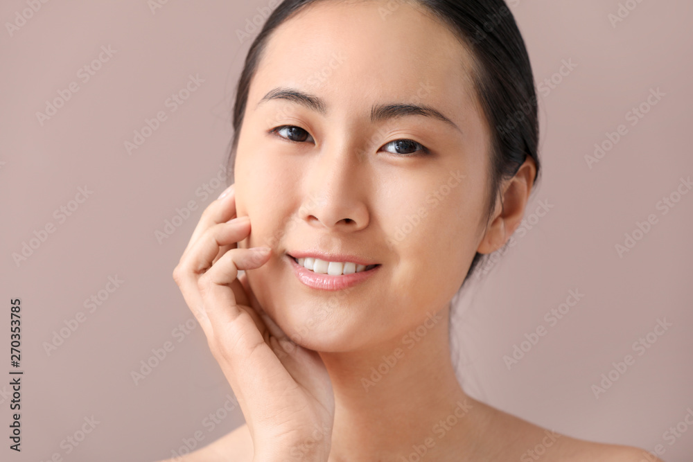 Asian woman before applying makeup on color background